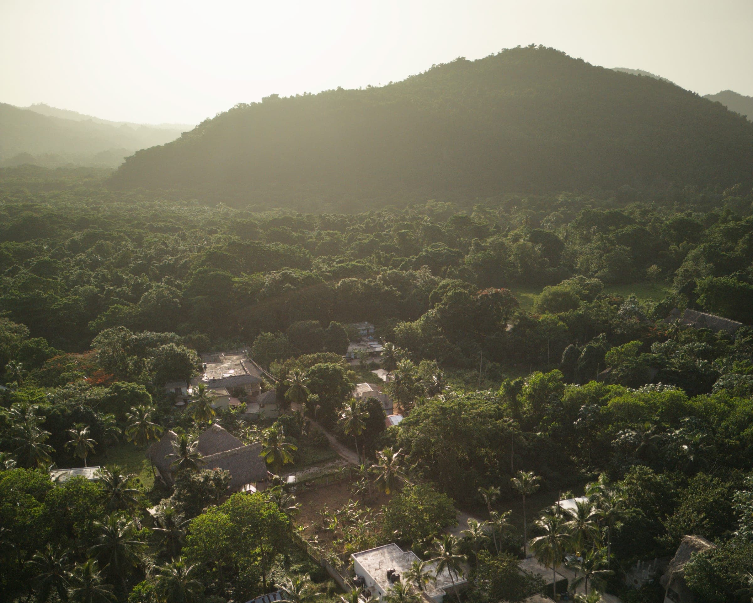 El Valle, Samaná at golden hour — jungle mountains meeting the Caribbean