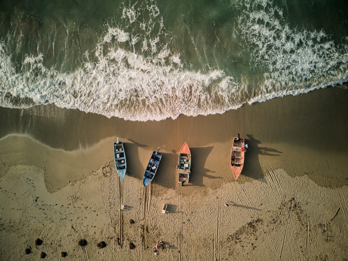 Fishing boats lined along the sand at Playa El Valle