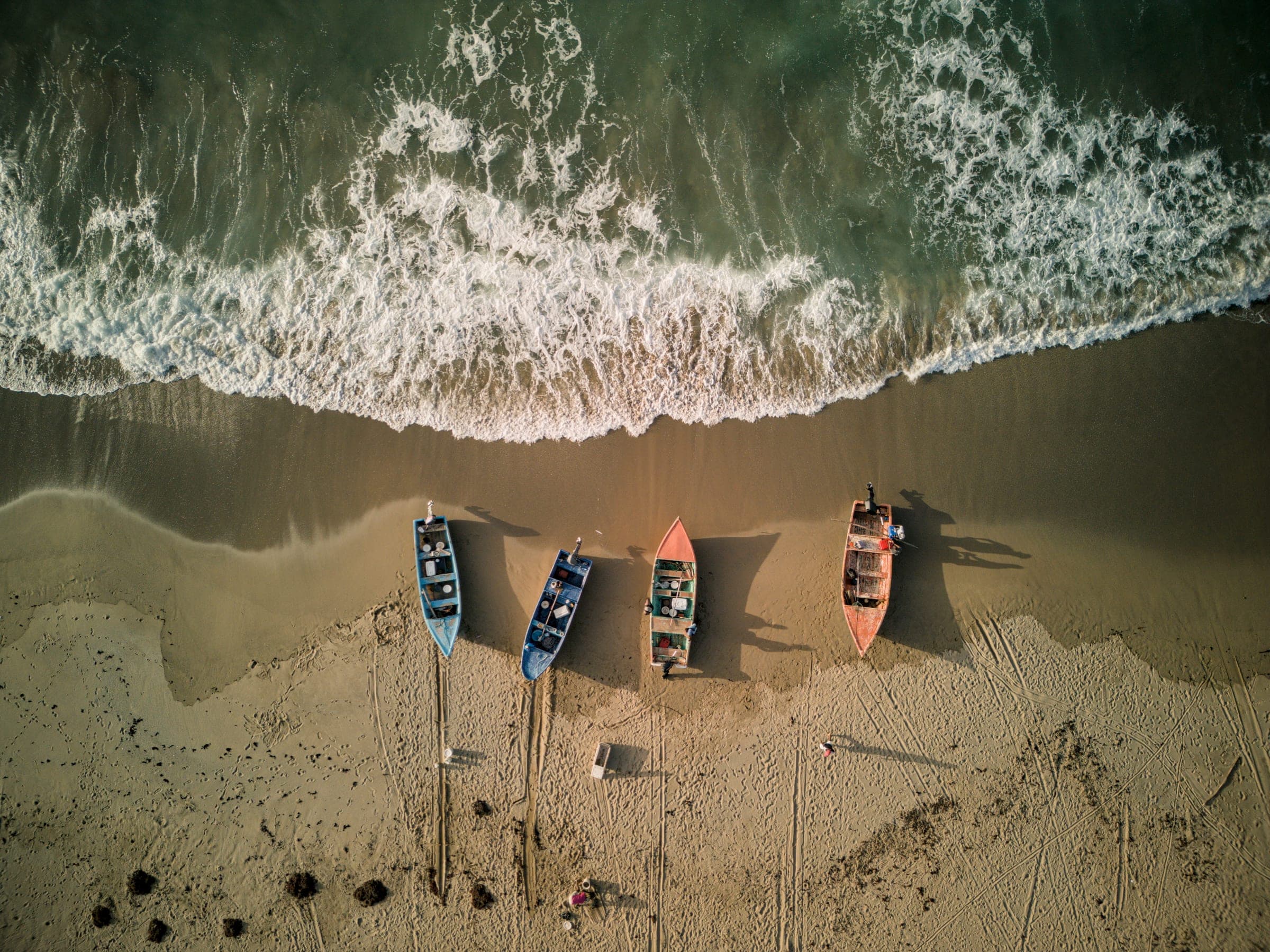 Fishing boats on the sand at Playa El Valle, top-down aerial view